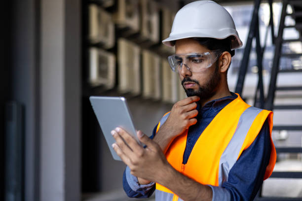 Senior engineer inspecting development progress with structural tablet specs